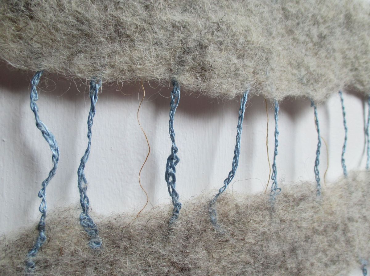 5 - Close up of crochet and yarn felted between strips of mixed breed grey wool